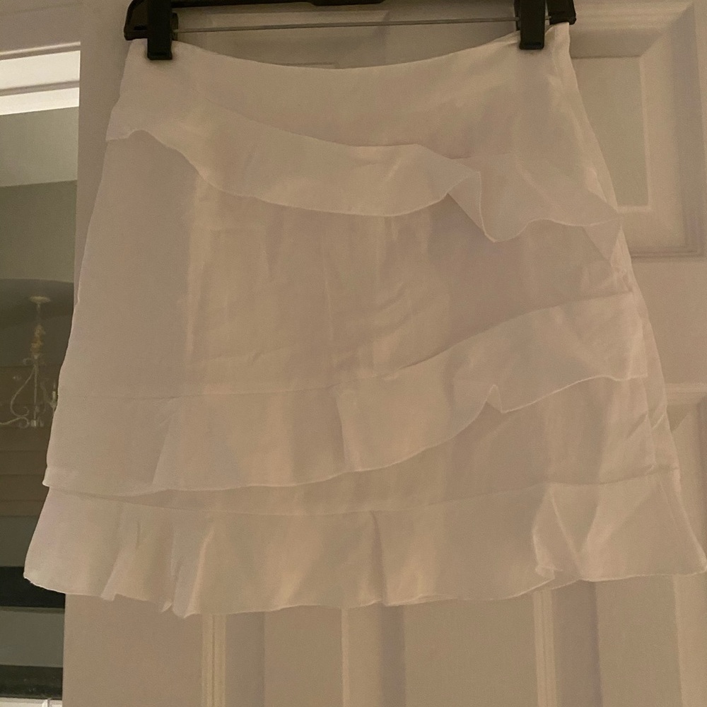 White skirt with ruffle.